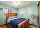 Comfortable bedroom featuring a wood-framed bed, hardwood floors and soothing mint-green walls at 1542 Kilkenny, Boulder, CO 80303