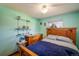 Bright bedroom showcasing a wooden bed frame, mint-green walls and open shelving at 1542 Kilkenny, Boulder, CO 80303