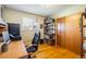 Bedroom featuring a desk, office chair, wood floors, and a built-in closet at 1542 Kilkenny, Boulder, CO 80303