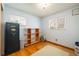 Bedroom with hardwood floors, two windows with blinds, and a modern shelf unit at 1542 Kilkenny, Boulder, CO 80303