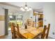 Bright dining room with light wood table and chairs, sliding glass door and chandelier lighting at 1542 Kilkenny, Boulder, CO 80303