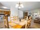 Bright dining room with a large table with chairs, a chandelier and view to the living area at 1542 Kilkenny, Boulder, CO 80303