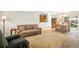 Cozy living room with a large couch, pass-through to dining room and soft, neutral carpet at 1542 Kilkenny, Boulder, CO 80303
