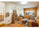 Comfortable living room with tile flooring, wood paneled wall and a large picture window at 1542 Kilkenny, Boulder, CO 80303