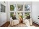 Bright sunroom with two comfy armchairs and plenty of natural light at 8387 S Reed St # B3, Littleton, CO 80128