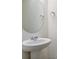 Small bathroom with pedestal sink and oval mirror at 889 Crest St, Lochbuie, CO 80603