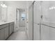 Main bathroom with double vanity and walk-in shower at 889 Crest St, Lochbuie, CO 80603