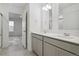 Main bathroom with double vanity and walk-in shower at 889 Crest St, Lochbuie, CO 80603