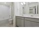 Modern bathroom boasts double vanity, a bathtub, and grey cabinets at 889 Crest St, Lochbuie, CO 80603