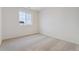 Bright bedroom with carpeted floor and a window offering an exterior view at 889 Crest St, Lochbuie, CO 80603