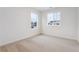 Spacious bedroom featuring carpeted floors and large windows at 889 Crest St, Lochbuie, CO 80603