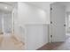 Upstairs hallway with carpet and doors to bedrooms at 889 Crest St, Lochbuie, CO 80603