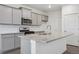 Modern kitchen with gray cabinets and granite countertops at 889 Crest St, Lochbuie, CO 80603