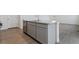 Kitchen island with granite countertop and gray cabinets at 889 Crest St, Lochbuie, CO 80603