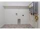 Bright laundry room with tile floor and water heater at 889 Crest St, Lochbuie, CO 80603