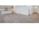 Bright living room featuring hardwood floors and access to kitchen at 889 Crest St, Lochbuie, CO 80603
