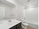 Bathroom features a white vanity with dark cabinets, a large mirror, and a shower-tub combination at 14536 Mellow Ct, Morrison, CO 80465