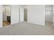 Spacious bedroom with neutral carpet and multiple doorways, creating an adaptable area with good flow to en-suite bath at 14536 Mellow Ct, Morrison, CO 80465