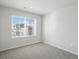 Bright bedroom with carpet flooring and a large window offering neighborhood views at 14536 Mellow Ct, Morrison, CO 80465