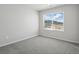 Bright bedroom featuring plush carpet, neutral walls, and a large window with mountain views at 14536 Mellow Ct, Morrison, CO 80465