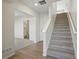 Bright entryway with staircase, wood-look flooring, and access to a half-bath at 14536 Mellow Ct, Morrison, CO 80465