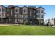 View of a modern townhome community with a well-maintained lawn and neutral color scheme at 14536 Mellow Ct, Morrison, CO 80465