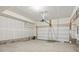 Spacious and unfinished two-car garage with high ceilings, ample storage, and a functional garage door at 14536 Mellow Ct, Morrison, CO 80465
