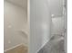 Neutral-toned hallway featuring carpeted floors and white walls leading to a stairwell, promoting a bright and modern feel at 14536 Mellow Ct, Morrison, CO 80465