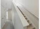 Carpeted stairway leading to the upper level, featuring white handrails and storage, enhancing a clean and inviting space at 14536 Mellow Ct, Morrison, CO 80465