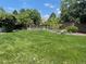 Expansive backyard featuring a meticulously maintained lawn and mature trees at 9798 Grove St, Westminster, CO 80031