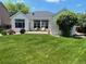 Landscaped backyard includes a patio seating area and well maintained lawn at 9798 Grove St, Westminster, CO 80031