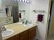 Bathroom featuring double sinks, updated fixtures, and glass-enclosed shower at 9798 Grove St, Westminster, CO 80031