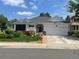 Charming single-story home with a well-manicured lawn and colorful flower beds at 9798 Grove St, Westminster, CO 80031