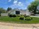 Well-maintained front yard featuring lush green grass, mature landscaping, and decorative rock accents at 9798 Grove St, Westminster, CO 80031