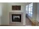 Living room featuring fireplace, view of yard through the window, and decor displayed on the wall at 9798 Grove St, Westminster, CO 80031