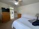 Spacious bedroom with ensuite bathroom, ceiling fan, and warm-toned decor at 9798 Grove St, Westminster, CO 80031