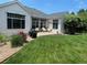 Charming patio with awning, lush landscaping, and an inviting outdoor living space at 9798 Grove St, Westminster, CO 80031