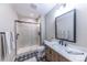 This is a well-lit bathroom featuring a glass shower with black trim and modern fixtures at 6759 Canyonpoint Rd, Castle Pines, CO 80108