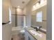 Bathroom featuring a shower over bath with tile surround and a vanity with light countertops and neutral paint at 6759 Canyonpoint Rd, Castle Pines, CO 80108
