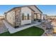 Beautiful home exterior with a covered patio, outdoor fireplace, and well-maintained landscaping at 6759 Canyonpoint Rd, Castle Pines, CO 80108