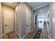 Hallway featuring hard wood floors, and sliding barn doors with an adjacent view of the living room at 6759 Canyonpoint Rd, Castle Pines, CO 80108