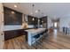 Kitchen featuring stainless appliances, a large center island with seating, and wood floors at 6759 Canyonpoint Rd, Castle Pines, CO 80108
