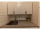 Clean laundry room with white cabinets and a large utility sink at 6759 Canyonpoint Rd, Castle Pines, CO 80108