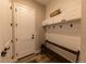 Convenient laundry room with storage cabinets and bench at 6759 Canyonpoint Rd, Castle Pines, CO 80108