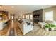 Bright living room with stone fireplace, comfortable seating, and open layout into the kitchen, perfect for modern living at 6759 Canyonpoint Rd, Castle Pines, CO 80108