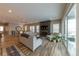 Open concept living room with dining area and living space with large windows and modern fireplace and entertainment center at 6759 Canyonpoint Rd, Castle Pines, CO 80108