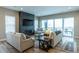 Cozy living room featuring a stone fireplace, comfortable seating, and natural light, perfect for relaxing and entertaining at 6759 Canyonpoint Rd, Castle Pines, CO 80108