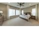 This main bedroom has a ceiling fan, large windows, and beautiful natural light at 6759 Canyonpoint Rd, Castle Pines, CO 80108