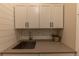 Stylish mudroom sink area featuring white cabinets and a gray countertop at 6759 Canyonpoint Rd, Castle Pines, CO 80108