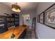 Well-decorated office space featuring a rustic wooden desk, unique decor, and ample storage with a tall, dark bookcase at 6759 Canyonpoint Rd, Castle Pines, CO 80108